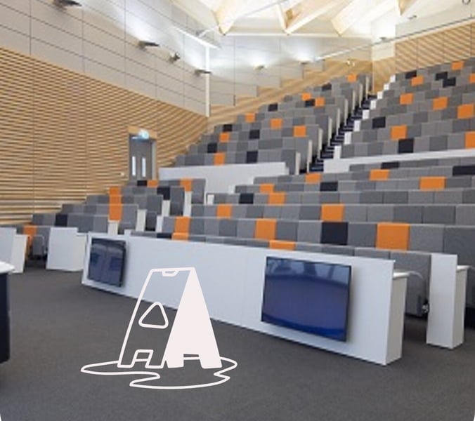 lecture hall with graphic of caution sign on the floor.
