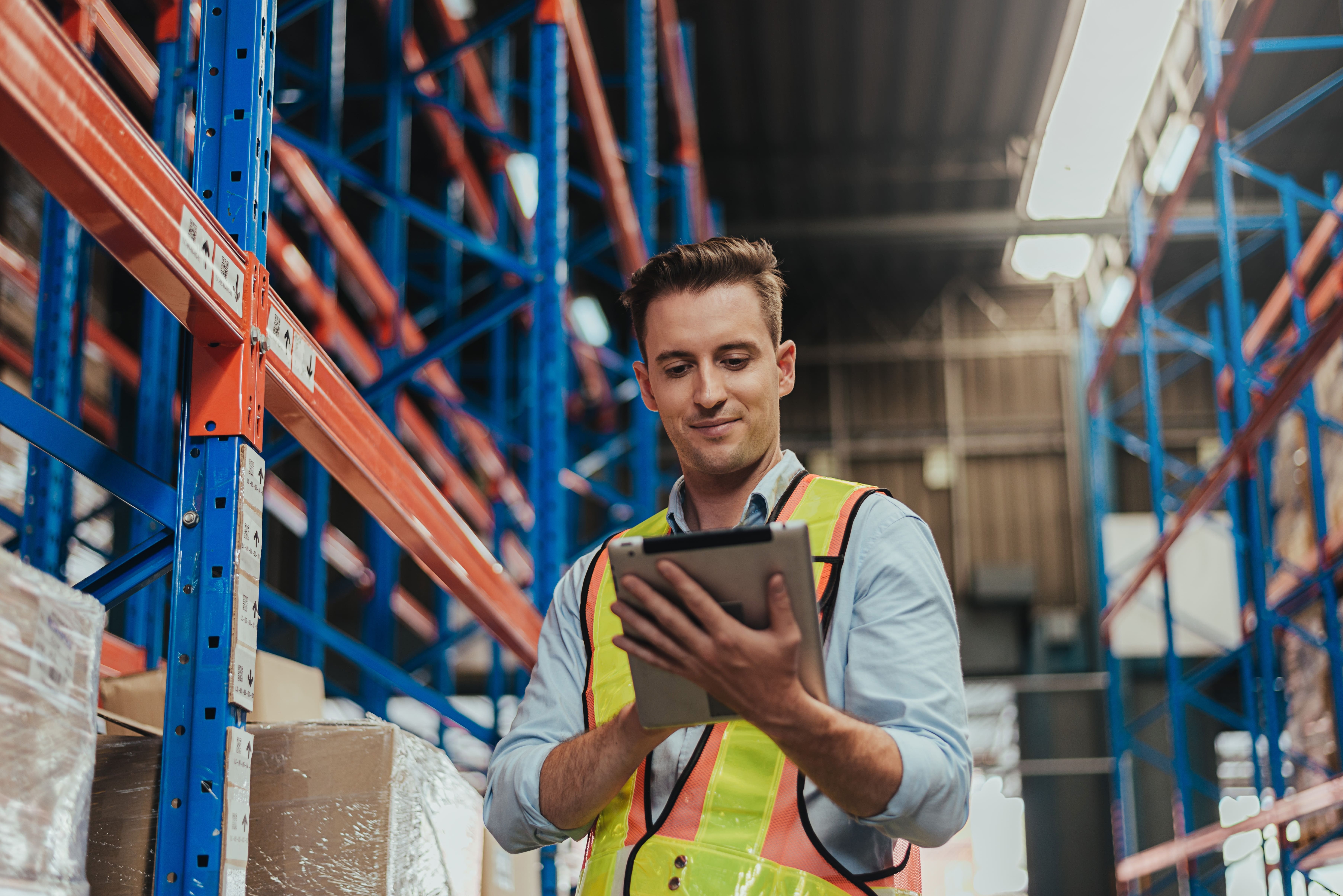 EHS professional with tablet in warehouse