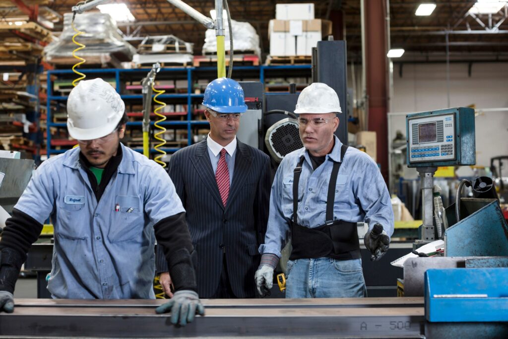 A health and safety manager looking at workers performing task